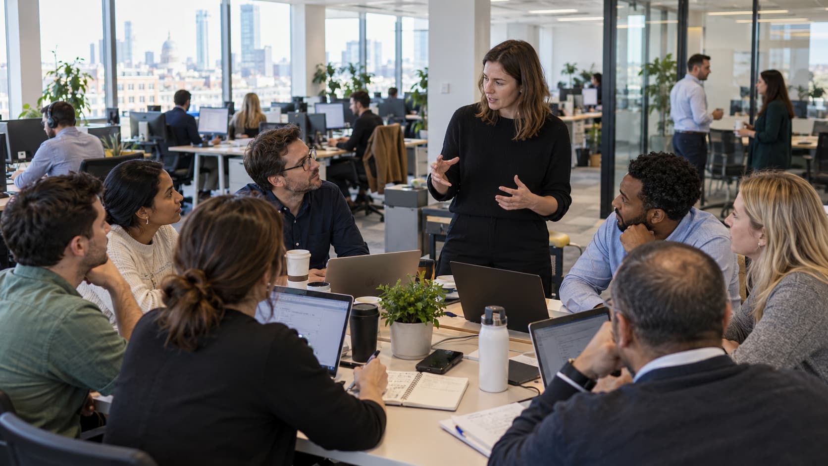 colleagues holding a meeting in a busy office