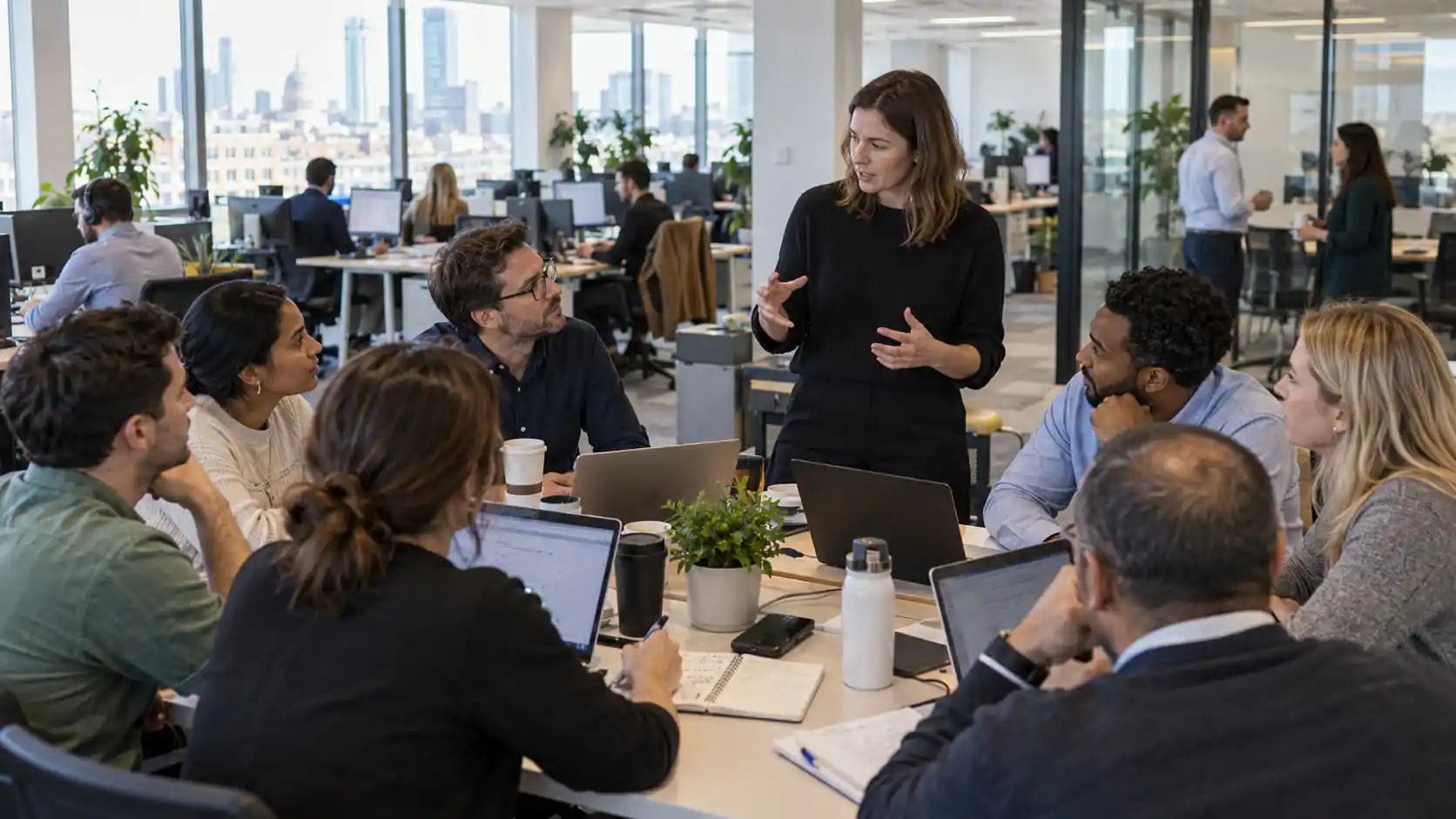 colleagues holding a meeting in a busy office